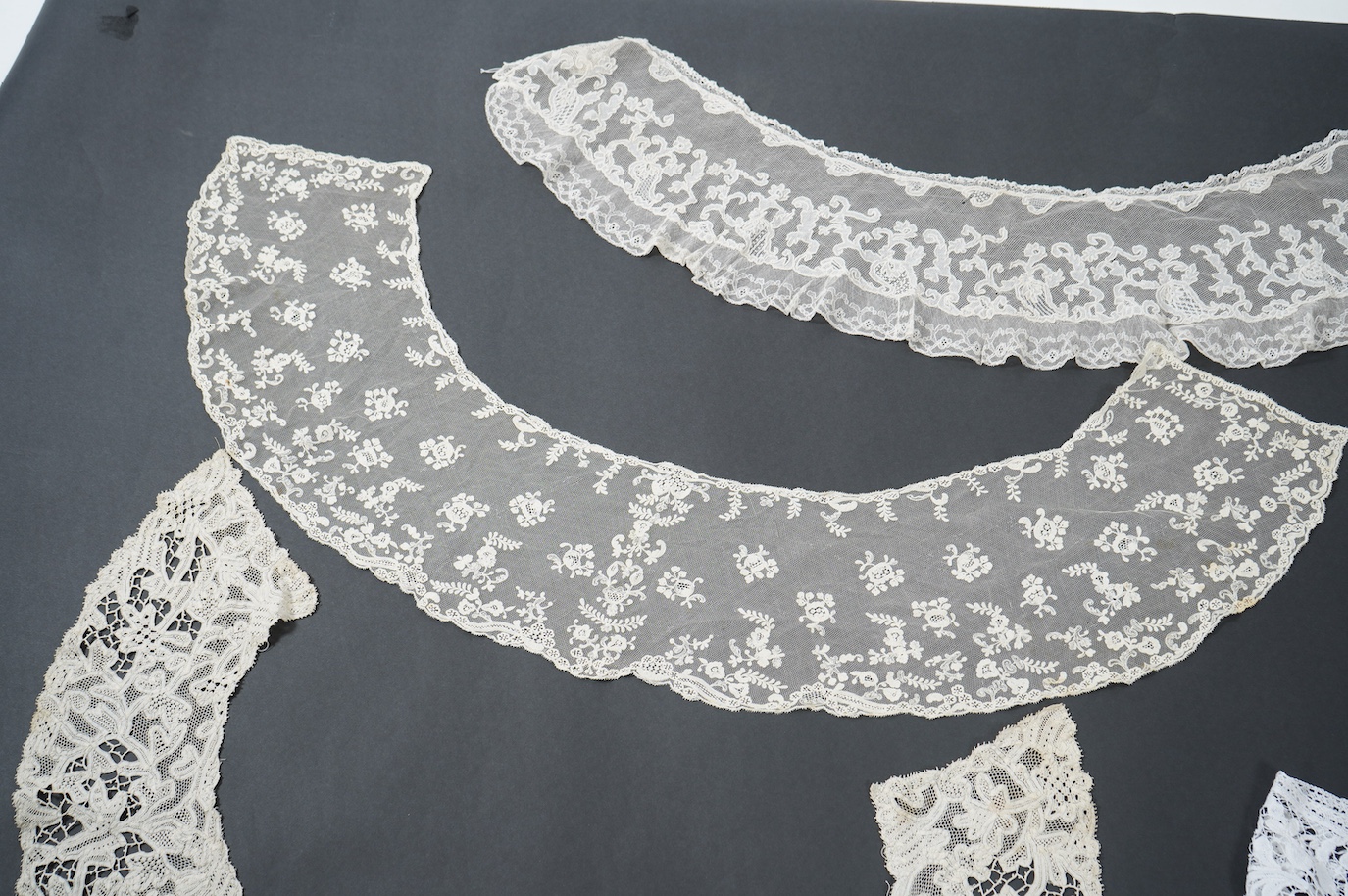 Seven late 19th century collars and trimming, being a long wide length of bobbin lace trimming - 268cm, two similar Bruges cream lace collars, an Irish Carrick-ma-cross collar, a fine needle run collar and another with a